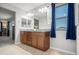 Well-lit bathroom with double sinks, granite countertops, and modern fixtures at 4115 S 180Th Dr, Goodyear, AZ 85338