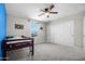 Bright bedroom with blue accent wall, carpet, window, ceiling fan, and closet at 4115 S 180Th Dr, Goodyear, AZ 85338