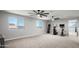 Large bonus room offering flexible space for a home gym or recreation area at 4115 S 180Th Dr, Goodyear, AZ 85338