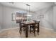 Well-lit dining room with a dark wood table set for four, and contemporary pendant lighting at 4115 S 180Th Dr, Goodyear, AZ 85338