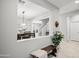 Inviting entryway with neutral walls, stylish decor, bench with throw, and tile floors leading to the dining room at 4115 S 180Th Dr, Goodyear, AZ 85338