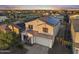 Two-story home featuring a tiled roof, solar panels, and a welcoming front porch, complemented by a well-manicured yard at 4115 S 180Th Dr, Goodyear, AZ 85338