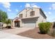 Inviting two-story home with a desert landscaped yard, a two-car garage and American Flag on the porch at 4115 S 180Th Dr, Goodyear, AZ 85338