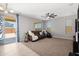 Comfortable living room with ceiling fan and sliding door to patio at 4115 S 180Th Dr, Goodyear, AZ 85338
