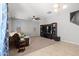 Inviting living room with entertainment center, ceiling fan, and neutral decor at 4115 S 180Th Dr, Goodyear, AZ 85338