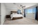 Bright main bedroom featuring a large bed, soft carpet, and natural light at 4115 S 180Th Dr, Goodyear, AZ 85338