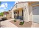 A covered porch with table and chairs providing a relaxing outdoor space, and low-maintenance desert landscaping at 4115 S 180Th Dr, Goodyear, AZ 85338