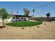 Well-manicured backyard with lush lawn and a serene pool area is perfect for relaxation at 4337 E Wilshire Dr, Phoenix, AZ 85008