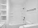 Modern bathroom features tub/shower combo, built-in shelving, and updated fixtures at 4337 E Wilshire Dr, Phoenix, AZ 85008
