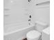 Modern bathroom features tub/shower combo, built-in shelving, and updated fixtures at 4337 E Wilshire Dr, Phoenix, AZ 85008