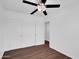 Bright bedroom featuring wood-look flooring, ceiling fan, and closet at 4337 E Wilshire Dr, Phoenix, AZ 85008