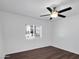Bedroom with ceiling fan features wood floors, neutral paint, and good natural light at 4337 E Wilshire Dr, Phoenix, AZ 85008
