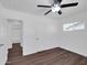 Bright bedroom featuring wood-look flooring, ceiling fan, and an ensuite bathroom at 4337 E Wilshire Dr, Phoenix, AZ 85008