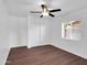 Bright bedroom featuring wood-look flooring, ceiling fan, and closet at 4337 E Wilshire Dr, Phoenix, AZ 85008
