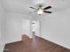 Bright bedroom boasts modern ceiling fan, and wood flooring with open doorway at 4337 E Wilshire Dr, Phoenix, AZ 85008