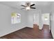 Bright bedroom featuring wood-look flooring, ceiling fan, and natural light at 4337 E Wilshire Dr, Phoenix, AZ 85008