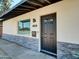 Close up of front entry featuring updated door, stacked stone accent, updated windows and hardware at 4337 E Wilshire Dr, Phoenix, AZ 85008