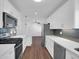 Modern kitchen with gray backsplash, stainless appliances and quartz countertops at 4337 E Wilshire Dr, Phoenix, AZ 85008
