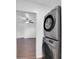 View of laundry area with stacked washer dryer next to bedroom with ceiling fan at 4337 E Wilshire Dr, Phoenix, AZ 85008