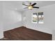 Bright living room boasts wood floors, modern ceiling fan, and a window with a pool view at 4337 E Wilshire Dr, Phoenix, AZ 85008