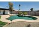 Backyard features a large pool, rock waterfall, and drought tolerant landscaping at 4337 E Wilshire Dr, Phoenix, AZ 85008