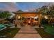 Stunning backyard with a cozy fire pit, a barbecue, and a rock waterfall, creating a peaceful and relaxing outdoor escape at 4450 S Frequency --, Mesa, AZ 85212