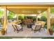 Relaxing backyard with a cozy seating area, fire pit, outdoor kitchen, and beautiful landscaping at 4450 S Frequency --, Mesa, AZ 85212