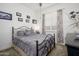 Comfortable bedroom featuring a wrought iron bed, soft lighting, and tasteful decor at 4450 S Frequency --, Mesa, AZ 85212