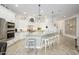 Bright, modern kitchen with white cabinets, stainless steel appliances, and a large center island with bar seating at 4450 S Frequency --, Mesa, AZ 85212