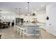 Spacious white kitchen featuring a large island with seating, granite countertops and modern appliances at 4450 S Frequency --, Mesa, AZ 85212