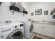 Bright laundry room with modern appliances, storage baskets, neutral walls, and a functional sink at 4450 S Frequency --, Mesa, AZ 85212