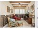 Rustic den featuring wood paneled walls, exposed wood beams, and comfortable seating. A warm and inviting space at 4450 S Frequency --, Mesa, AZ 85212