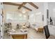 Cozy living area featuring wood-look floors, plantation shutters, exposed wood beams, and inviting neutral decor at 4450 S Frequency --, Mesa, AZ 85212