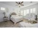 Serene main bedroom retreat with a decorative bed, ample natural light, and hardwood-style floors at 4450 S Frequency --, Mesa, AZ 85212