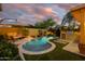 Resort-style pool with a built-in waterfall, outdoor kitchen, and lush landscaping, creating a serene backyard oasis at 4450 S Frequency --, Mesa, AZ 85212