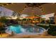 Luxurious backyard featuring a sparkling pool, built-in barbecue, and covered patio, perfect for outdoor entertaining at 4450 S Frequency --, Mesa, AZ 85212