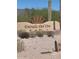 Entrance to the Entrade Del Oro community featuring a desert landscape, stone wall and monument sign at 48171 N La Soledad --, Gold Canyon, AZ 85118