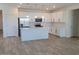 Bright kitchen features white cabinets, stainless steel appliances, a large island, and tile backsplash at 48171 N La Soledad --, Gold Canyon, AZ 85118