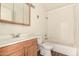Bathroom features a tub with a shower, toilet and vanity with a mirror at 5742 N 43Rd Dr, Glendale, AZ 85301