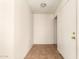 Clean entryway with tiled floors, white walls, and a door leading to other rooms at 5742 N 43Rd Dr, Glendale, AZ 85301