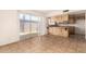 View of living room, sliding glass doors, and kitchen with wood cabinets at 5742 N 43Rd Dr, Glendale, AZ 85301