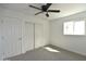 Bedroom features a ceiling fan, window and closet space at 6813 W Sherri Jean Ln, Peoria, AZ 85382