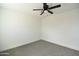 This bedroom features a modern ceiling fan and neutral carpet at 6813 W Sherri Jean Ln, Peoria, AZ 85382