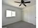 This bedroom features a closet, window and modern ceiling fan at 6813 W Sherri Jean Ln, Peoria, AZ 85382