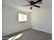 Bright bedroom with a ceiling fan, window, and neutral carpet at 6813 W Sherri Jean Ln, Peoria, AZ 85382