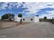 The white exterior of this home is complemented by a long driveway for extra parking at 6813 W Sherri Jean Ln, Peoria, AZ 85382