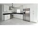 Renovated kitchen with stainless steel appliances, white cabinets and a modern chandelier at 6813 W Sherri Jean Ln, Peoria, AZ 85382