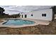 Rear of property featuring a well-maintained swimming pool with concrete patio and sleek architecture at 6813 W Sherri Jean Ln, Peoria, AZ 85382