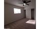 Bright bedroom with neutral carpet, ceiling fan, and large window, creating a relaxing and comfortable atmosphere at 720 S Dobson Rd # 24, Mesa, AZ 85202