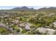 Panoramic aerial view featuring a luxurious estate with pool, tennis court, and lush green landscape in a residential area at 7272 N 71St St, Paradise Valley, AZ 85253